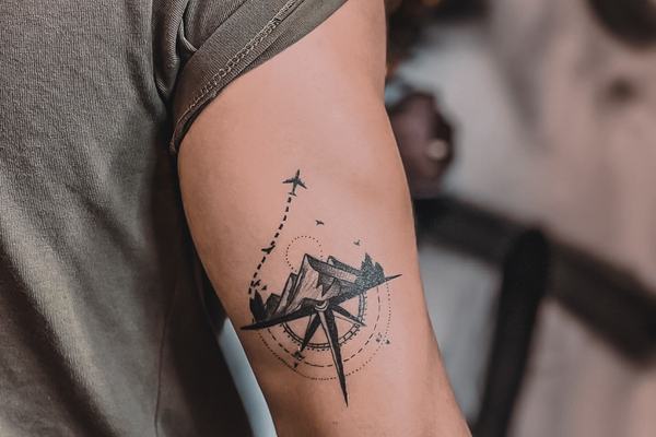 Fine line floral tattoo with detailed flower composition