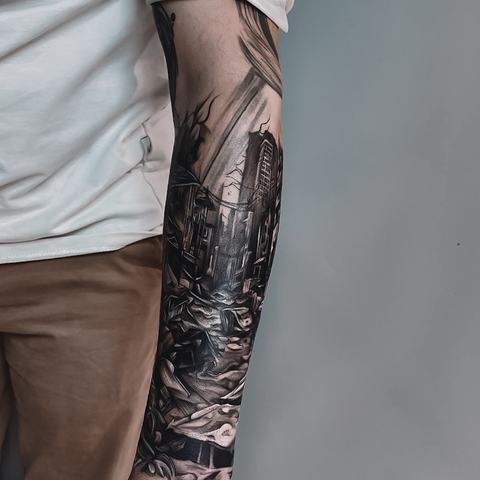 A full-arm sleeve combines architectural scenery, shadowed figures and dense illustrative details, creating a continuous dark composition from top to bottom