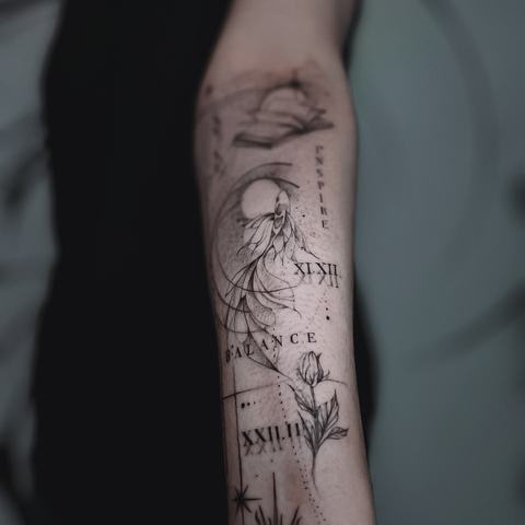 Fine botanical lines, Roman numerals and delicate lettering run down the inner forearm, forming a light vertical composition with subtle celestial motifs