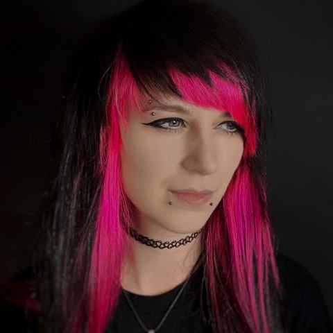 Eyebrow and lower lip piercings with a bold, alternative finish that matches the client’s bright, expressive style. The jewellery adds sharp facial accents while keeping the placement balanced, with sterile technique and clear aftercare guidance for