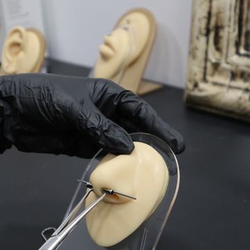 Ear piercing practice on silicone model