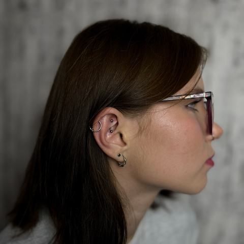 Curated ear piercing with multiple cartilage and lobe accents for a layered, stylish look. The jewellery was positioned to follow the natural shape of the ear, creating a neat and balanced composition.