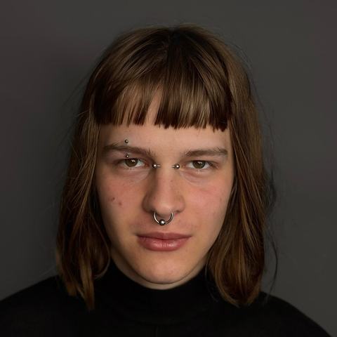 Septum and eyebrow piercing with a sharp, symmetrical finish. The jewellery adds definition to the face while keeping the overall style minimal, with precise placement and aftercare advice provided.